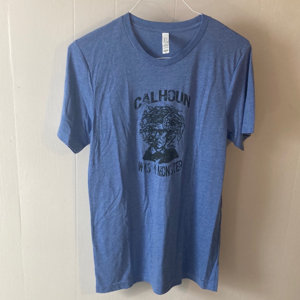 New Bella and Canvas heather blue custom shirt. Says “Calhoun was a monster”.